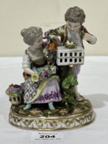 A 19th Century Dresden porcelain group allegorical of spring, the girl holding a flower garland