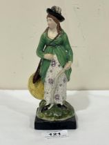 An early 19th Century Staffordshire figure of a lady archer. 7¼" high