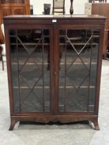 A mahogany bookcase enclosed by a pair of astragal glazed doors, on splayed bracket feet. 41" wide