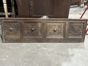 A late 17th Century joined oak carved panel. 47" wide.