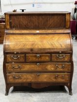 A 19th Century cylinder bureau in the French manner, the upper part enclosed by a tambour shutter,