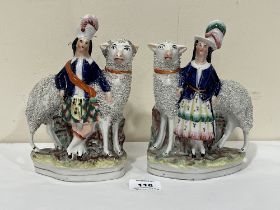 A pair of 19th Century Staffordshire figures of a Scottish gentleman and lady with sheep. 8" high