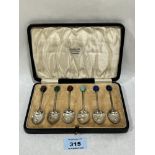 A cased George V set of six silver coffee spoons with hardstone bean finials. Birmingham 1923.
