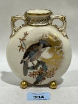 A Royal Worcester moonflask, gilded and painted with a bird on a branch. 5" high.