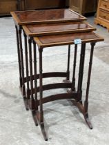 An Edward VII mahogany and line inlaid nest of occasional tables on ring turned spider legs.