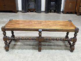 A joined oak luggage stand bearing a plaque stating 'Made from timber taken from H.M.S. Renown',