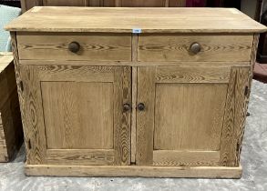 A Victorian pine cupboard with a pair of drawers over conforming panel doors. 50" wide.