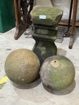 A sandstone garden plinth and a pair of spheres.