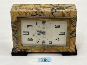 A 1930s French Art-Deco marble cased mantle timepiece. 8" wide. Chip to slate foot.