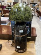 A Howitzer Dopp Z c.91 shell based table lamp with helmet shade.