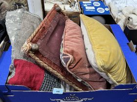 A patchwork quilt, a footstool and two cushions.