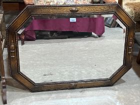 An oak framed wall mirror with bevelled plate. 34" wide.