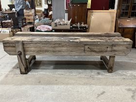 An oak carpenter"s bench. 108" wide.