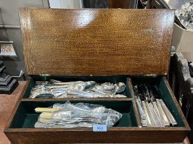 An oak cutlery box with plated cutlery.