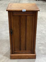 An oak channel moulded pot cupboard.