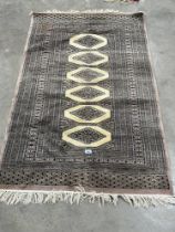 An Eastern rug, 61" x 38".