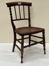 A Victorian simulated rosewood child"s chair with caned seat. 23" high.