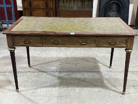 A mahogany writing table with applied gilt brass mounts, the tooled leather inlet top over three