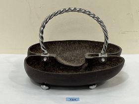 A coco-de-mer basket with rope-twist white metal handle. 12" wide.