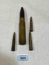 A 20mm ammunition cartridge and three smaller.