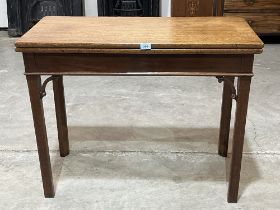 A George III mahogany tea table, raised on chamfered square legs. 36" wide.