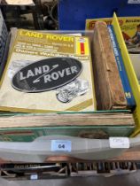 A box of Land Rover manuals and a box of diecast model vehicles.