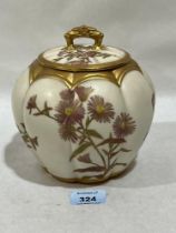 A Royal Worcester blush ivory jar and cover, gilded and painted with flowers. Shape 1412. 6½" high.