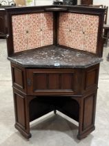 A Victorian mahogany corner washstand, the marble top with tiled splashback. 31" wide.