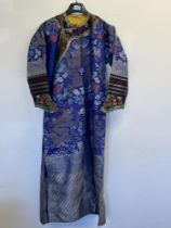 A Chinese silk robe, embroidered with dragons and auspicious objects on a blue ground. 55" long.