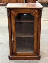 A Victorian walnut inlaid pier cabinet, enclosed by a glazed door. 20"w x 33½" h.