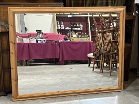 A pine framed wall mirror with bevelled plate. 53" x 41".