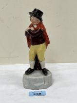 An early 19th Century Staffordshire pearlware figure of a man in a cape. Signed Olive Wood to