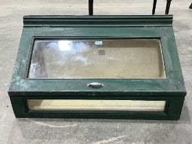 A painted display case, 32½" wide.