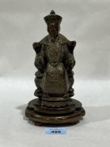 A bronzed composition figure of an enthroned emporer.