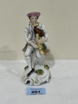 A 19th Century Staffordshire figure of a bagpipe player. 6" high.