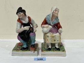 A pair of early 19th Century Staffordshire figures, seated cobbler and female companion. 6½" high.