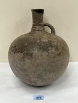 An African earthenware globular vessel. 10½" high.