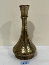 A 19th Century middle Eastern brass vase with wriggle-work decoration. 9½" high.