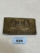 A bronze Rolls-Royce belt buckle.