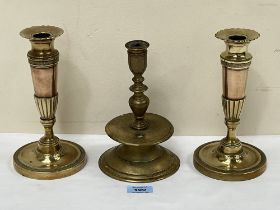 A late 16th Century style brass capstan candlestick, 8" high and a pair of brass candlesticks.