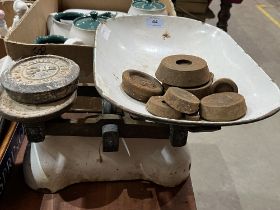 A set of weighing scales and weights.