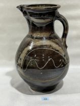 A glazed studio pottery jug. Impressed monogram signature to handle. 17¼" high.