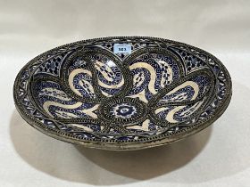 A Moroccan blue and white decorated and wire applied "fez" bowl. 15½" diam.