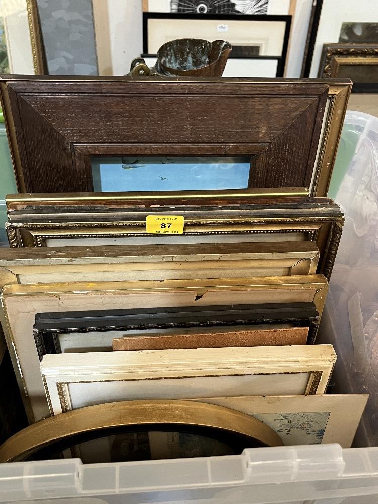 A box of pictures and frames.