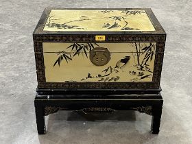 A Chinese black lacquer chest with gilt decoration of birds and prunus. 23" wide.