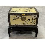 A Chinese black lacquer chest with gilt decoration of birds and prunus. 23" wide.