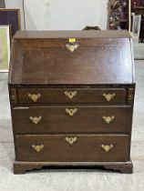 An 18th Century oak bureau with fitted interior over three drawers on bracket feet. 30½" wide