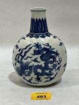 A Chinese globular vase decorated in blue and white with dragons, birds and foliage. 6¼" high.