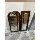 A pair of mahogany arch framed mirrors and another with oak frame.