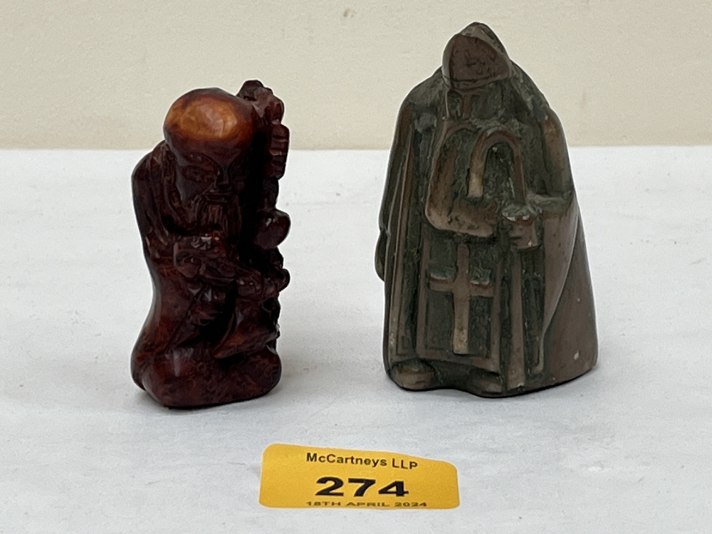 A bronzed resinous chess piece and a netsuke